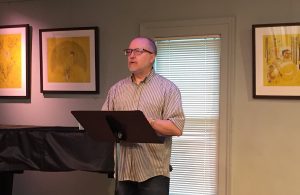 David Hile speaking at his art exhibition